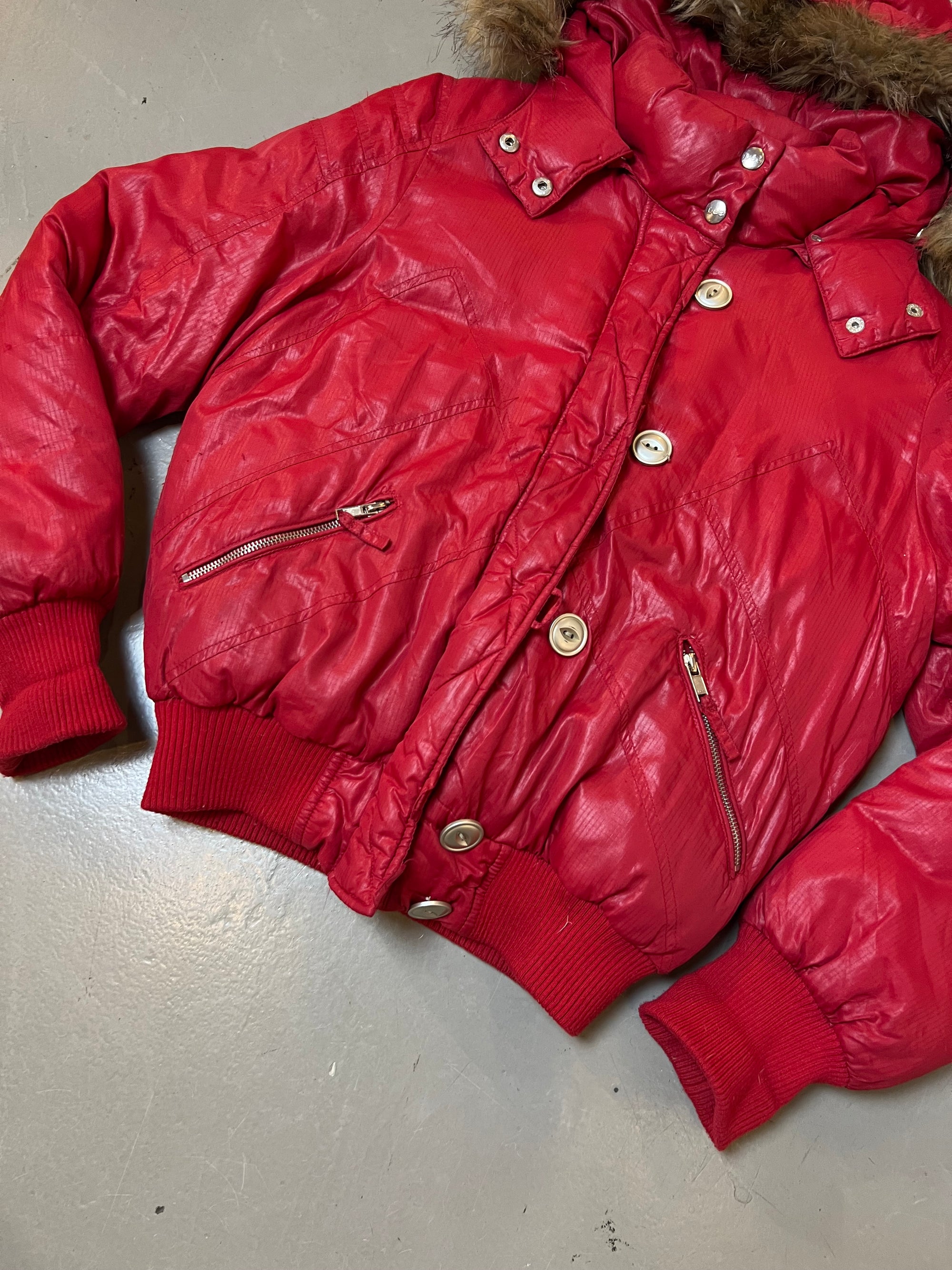 Zu sehen ist eine Pink/rote Pufferjacke von Lee cropped mit Fell Kaputze